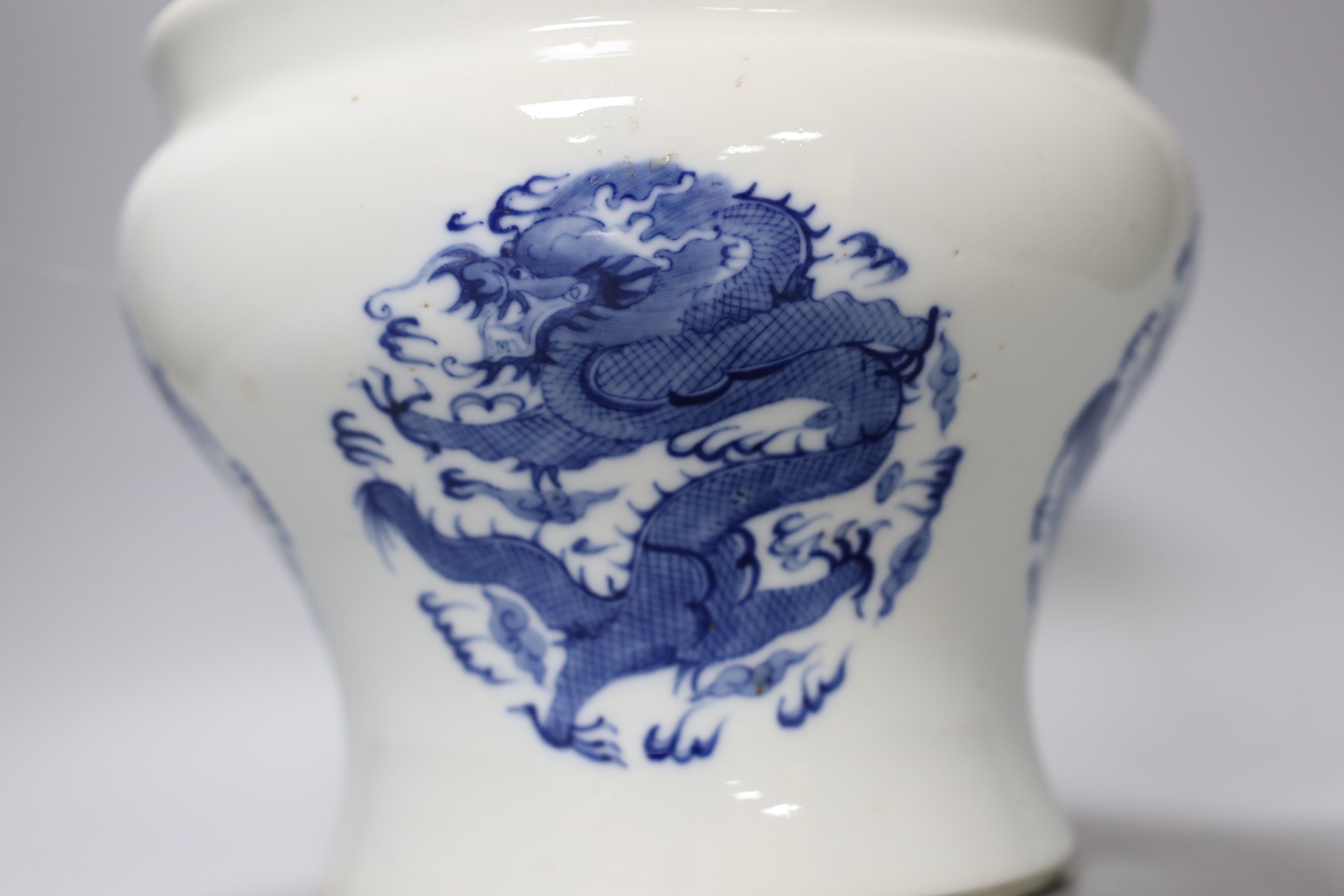 A Chinese under-glazed blue and white dragon bowl, 18cm tall